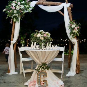 head table with wooden arbor